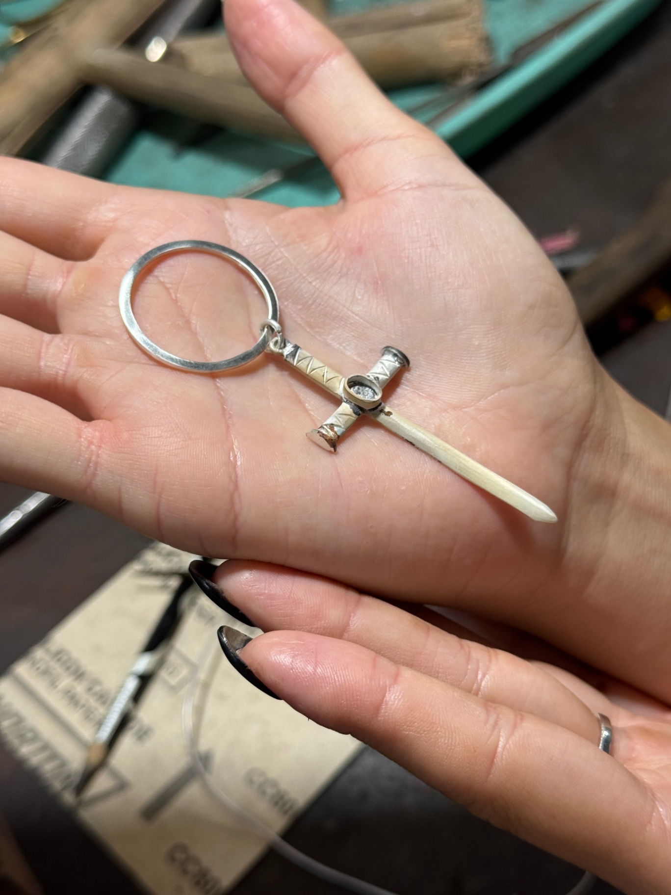 The finished Sapphire Cross resting in the palm of a hand
